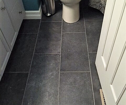 Bathroom floor with dark grey tile
