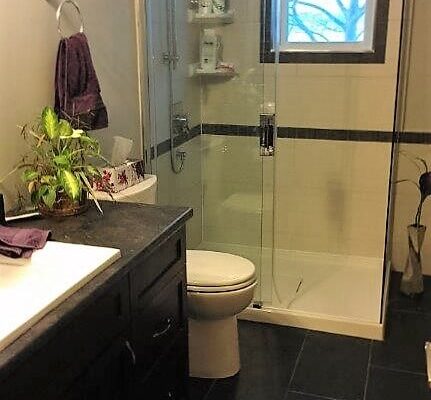 Bathroom with dark grey floor tile