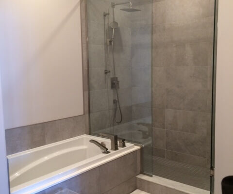 Tiled shower stall with separate tub