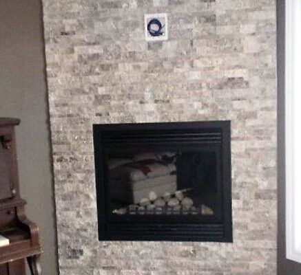 Corner fireplace with stone veneer.