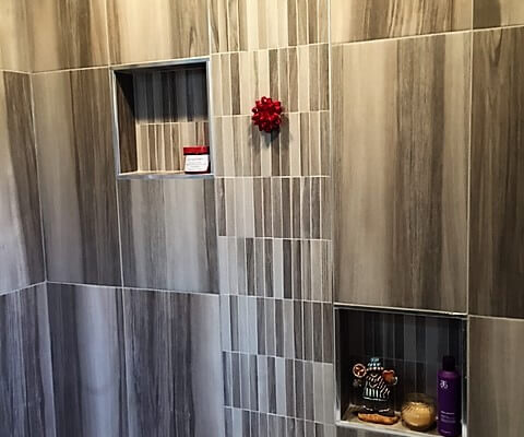 Shower with custom grey tile patterns