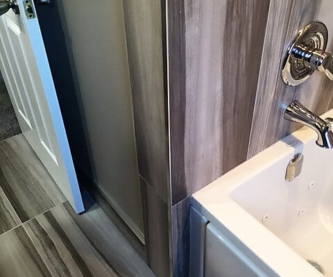 Bathroom with matching floor and tub surround tile