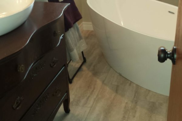 Bathroom with soaker tub and large floor tiles