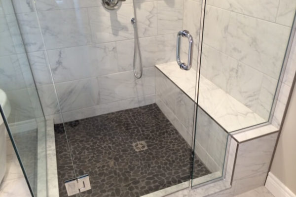 Shower stall with stone shaped tile on the floor